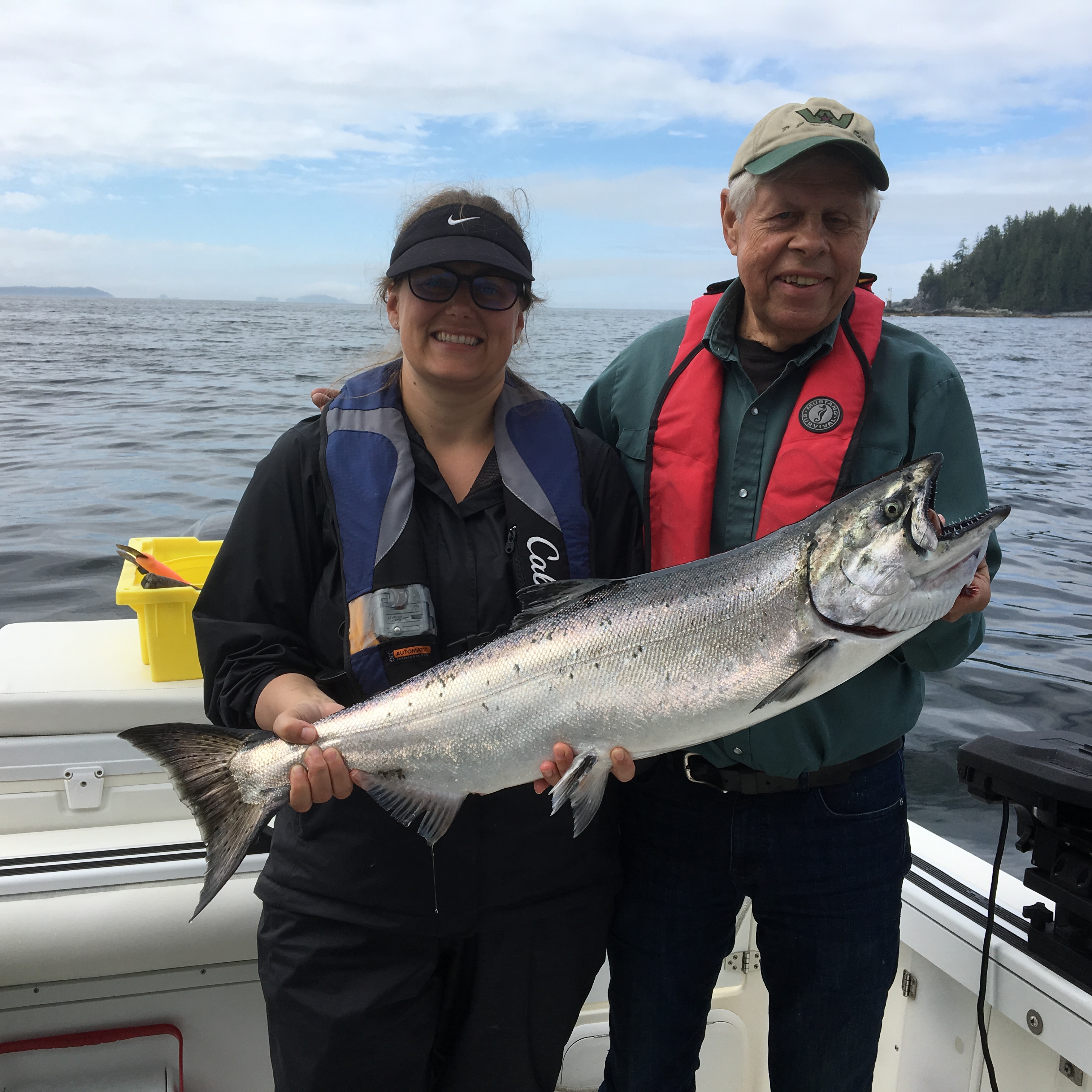 two people holding salmon