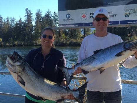 two people showing off their fish