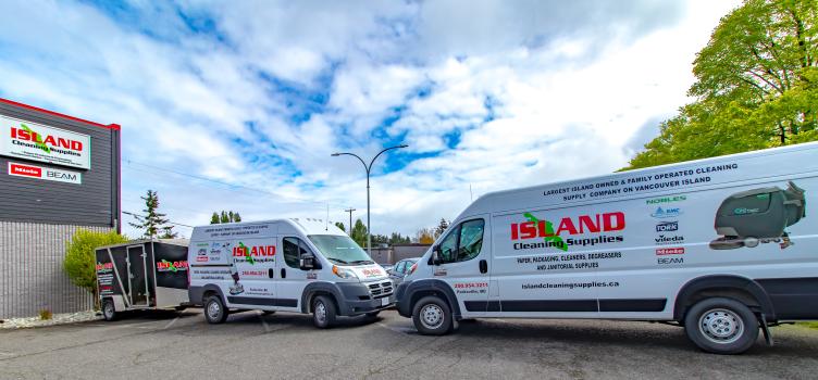 Two Island Cleaning Supplies vans parked nose to nose.